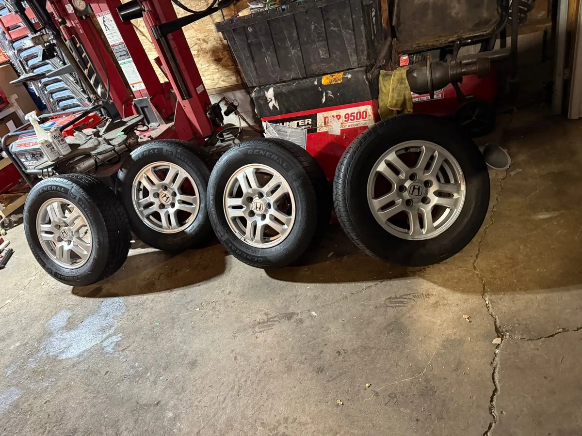 Four alloy wheels with new tires ready to install