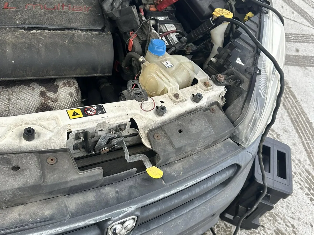 Jump start service on a car battery under the hood