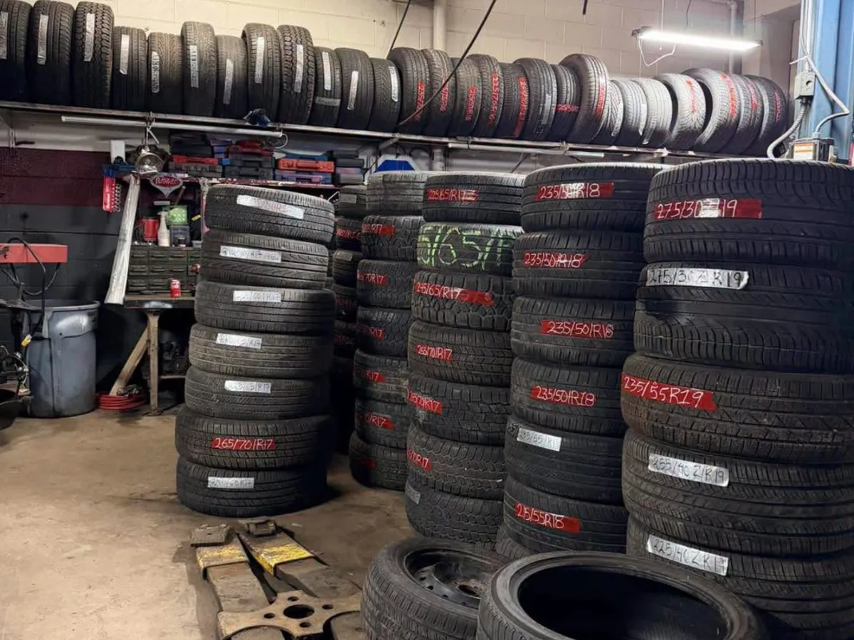 Stacked tire inventory inside a tire and repair shop