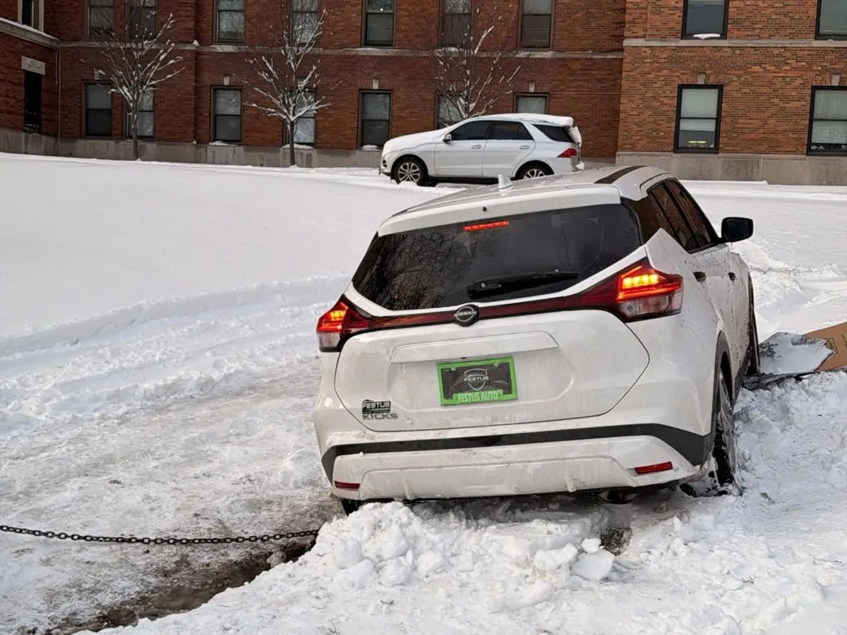 White SUV winched out of deep snow by a tow truck